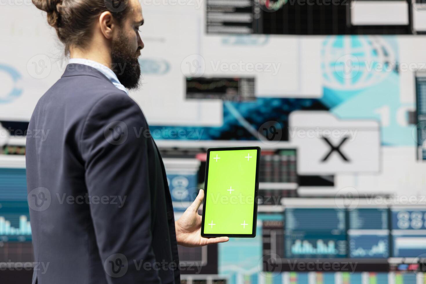Male administrator using chroma key display for a digital analysis, ensures financial planning and business success with digital growth driven tools and monthly reports. Insightfulness. photo
