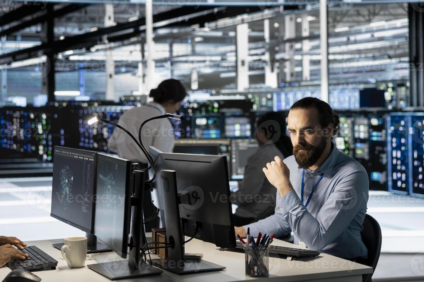 Technician using PC in data center to update server tech, configuring equipment using software tools. Server room employee reviewing hardware analytics, ensuring reliable network operations photo