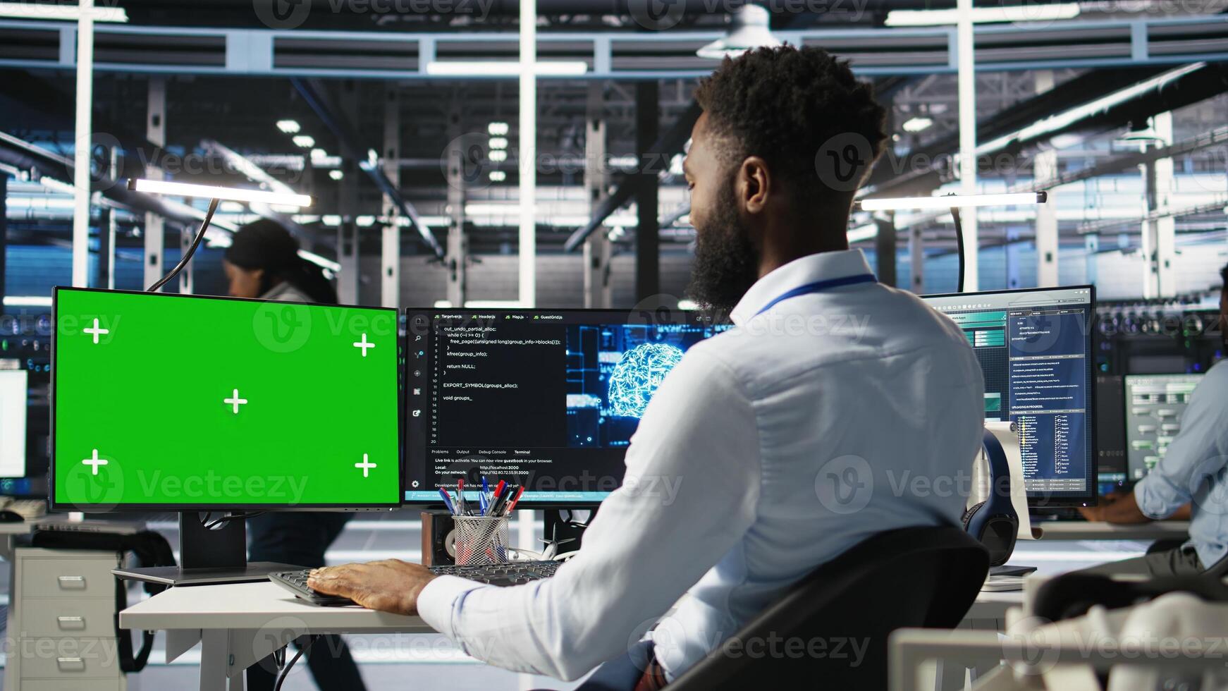 Data center admin using green screen PC to do node tree programming, optimizing resource allocation. Man in server room uses mockup computer predictive AI visualization systems, camera A photo