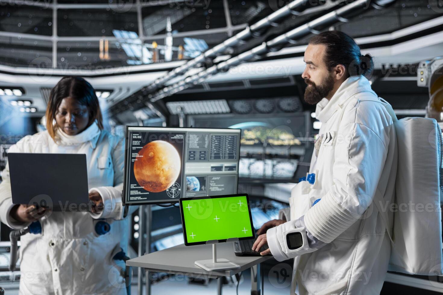 Astronaut checks green screen tablet interface before landing spaceship on Mars. Crew members looking at chroma key device during mission to red planet surface, testing human survival in deep space photo