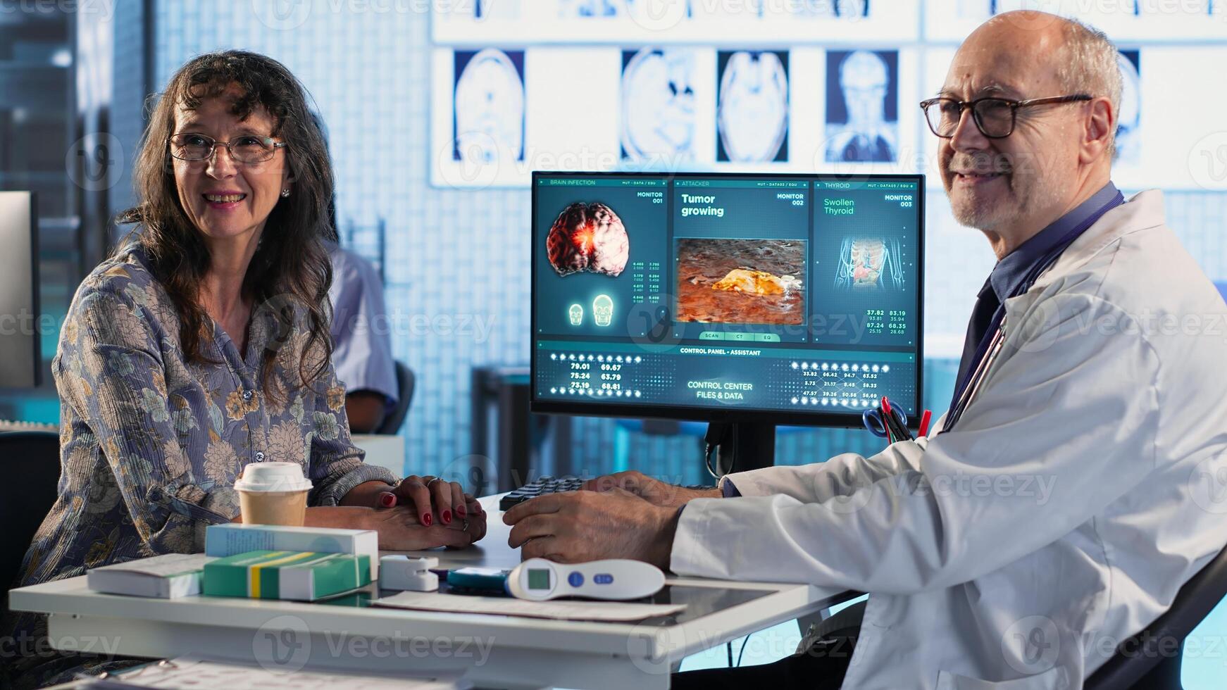 Doctor provides cancer screening to patient, discussing MRI scans and tumor growth. Early detection and preventative medicine emphasized for better health outcomes. Camera B. photo