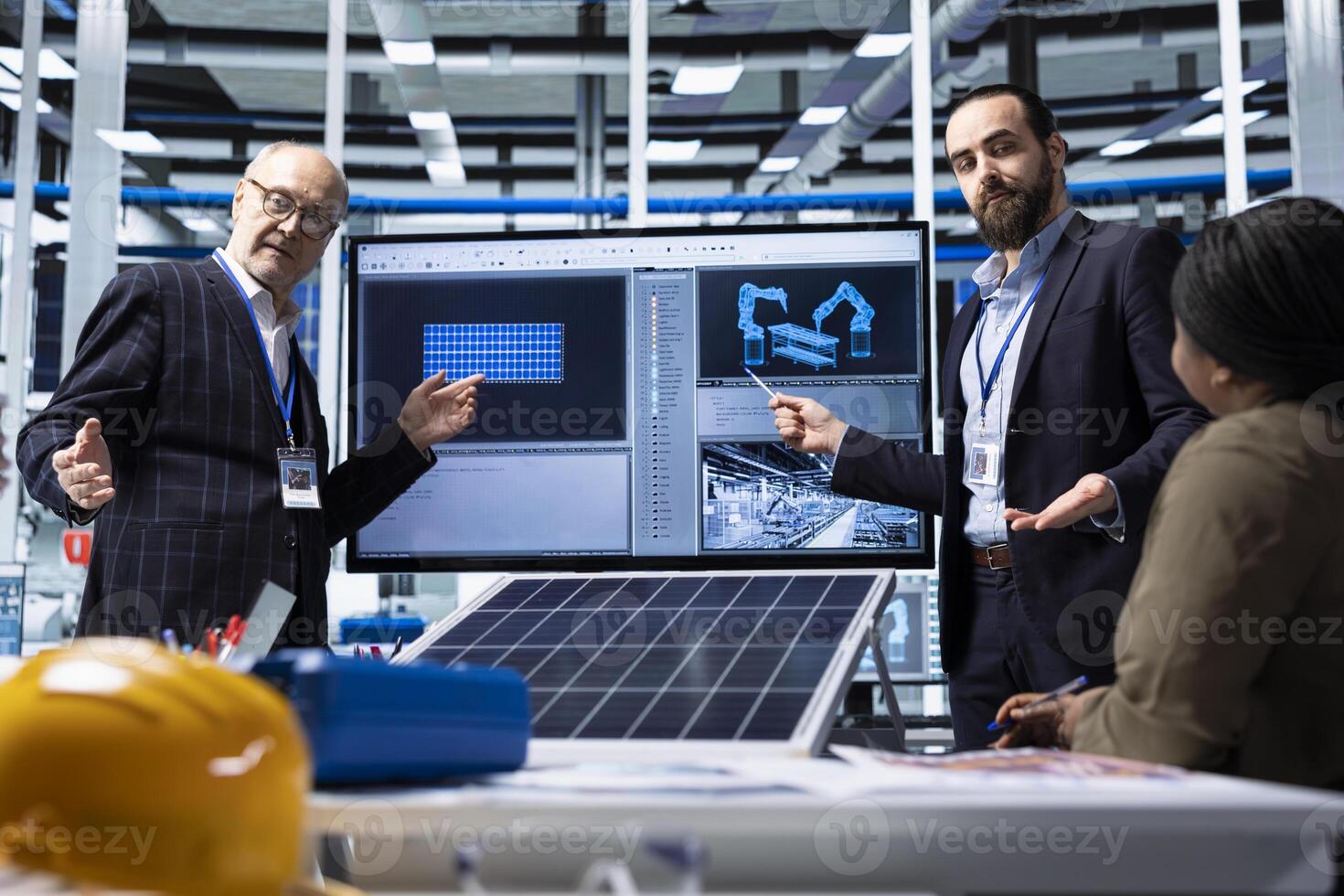 Factory businessmen doing sales presentation for shareholders, showing solar panel solutions. Industrial plant managers showcase product innovations in sustainable energy sector in front of investors photo