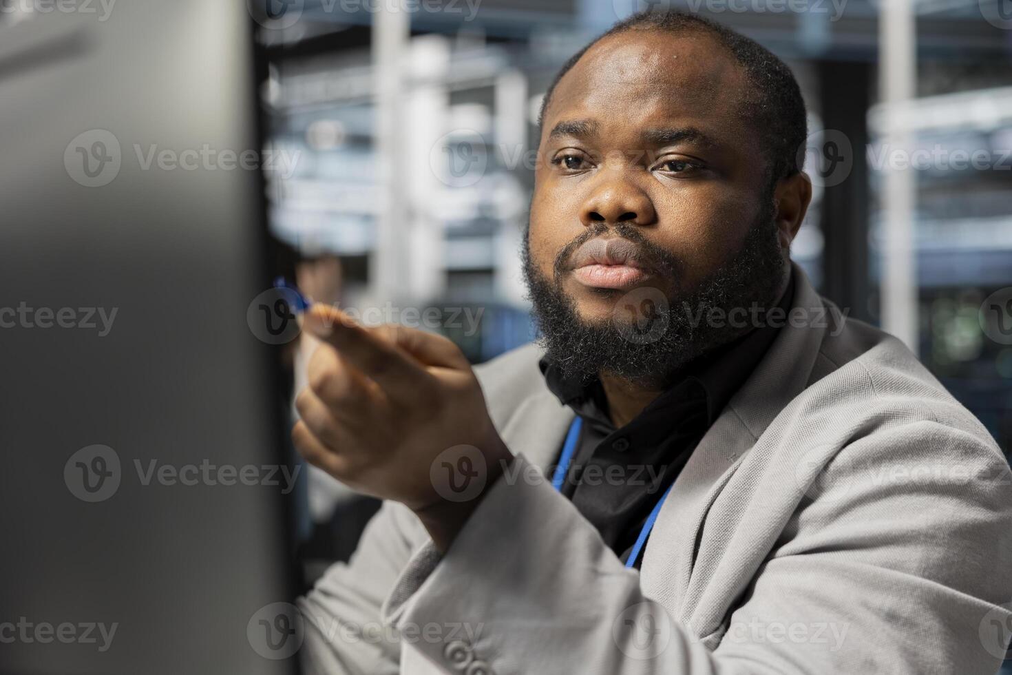 Data center computer scientist inspecting gear, doing maintenance tasks. Server farm worker looking at PC screen, conducting system checks to ensure operational stability across network rackmounts photo