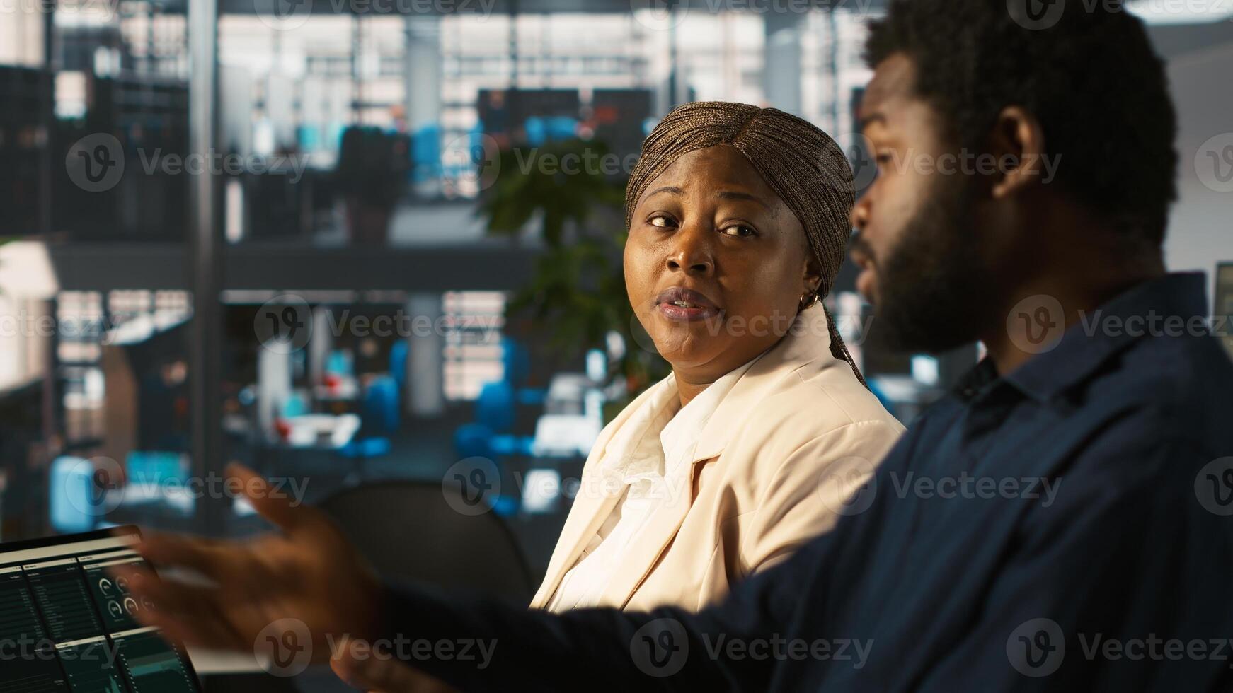 Angry manager in office berating worker for not hitting revenue key performance targets. Upset management executive fighting with employee at work scolding him for low output, camera A photo