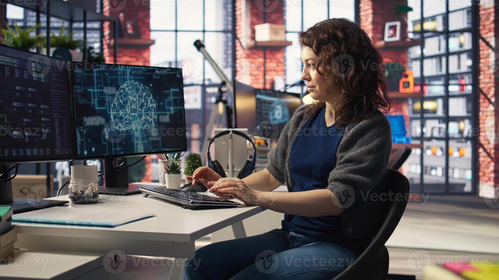 Teleworking developer using computer for artificial intelligence computing through self learning algorithms. Agency IT engineer works with AI deep neural networks on desktop PC. Camera A. photo