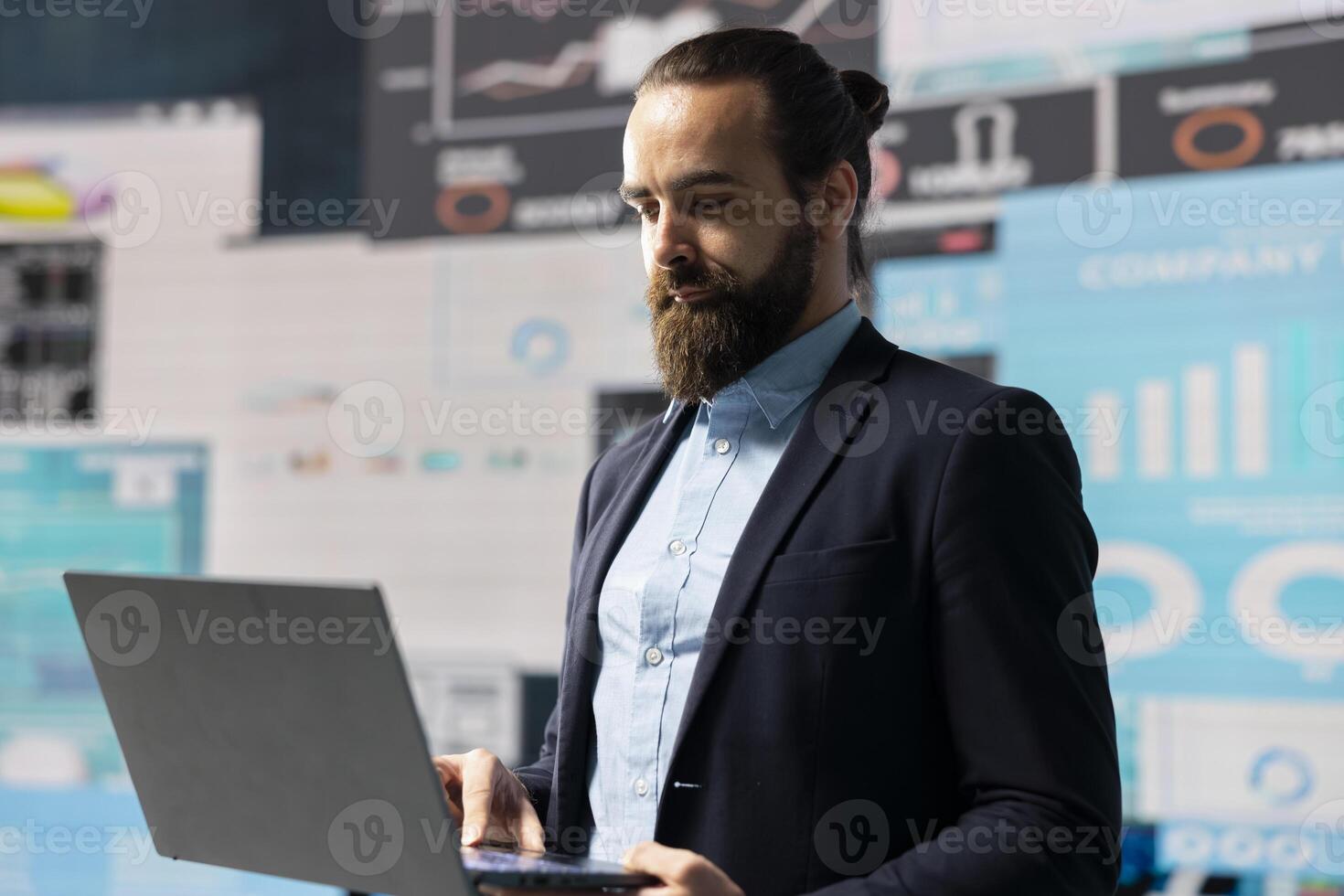 Data driven planning helps this professional to build a successful strategy for global business development. Using charts on dashboard and projections to guide his leadership ideas for growth. photo