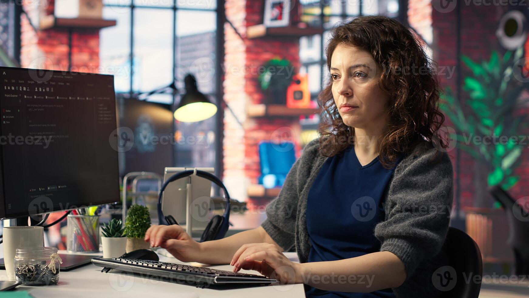 IT female technician uses coding language on computer at the agency, creating software to work on implementing algorithms. IT expert building applications with a programming interface. Camera B. photo