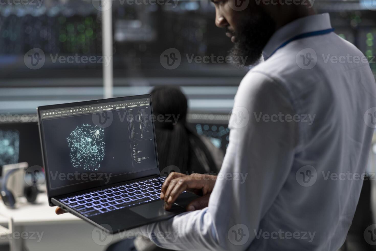 Data center engineer uses AI visualization tool on laptop to optimize resource allocation. Server hub IT expert uses artificial intelligence analysis on notebook to do maintenance photo