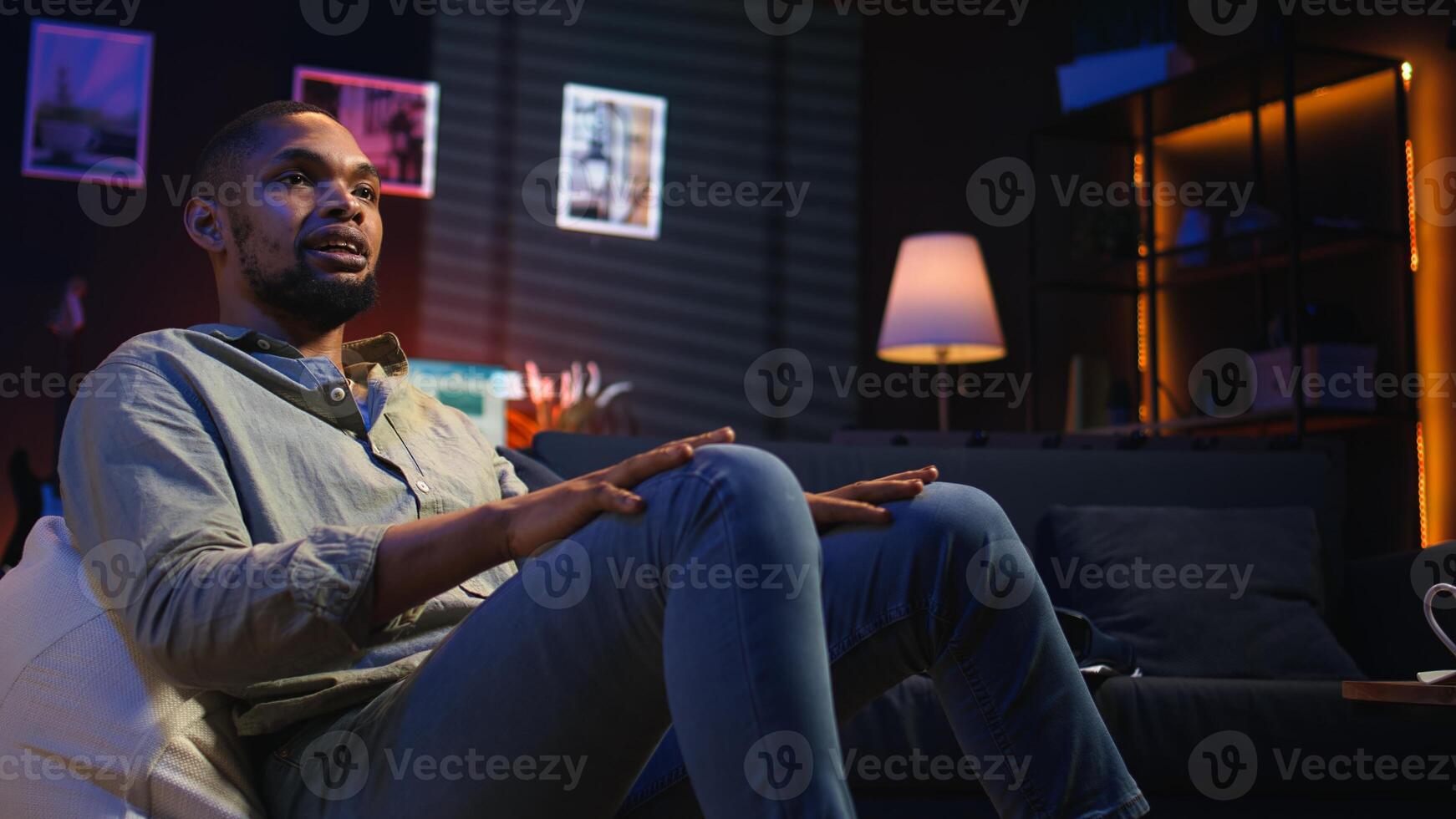 African american person smiling and chatting during a call at home, sharing insight for tasks completion with colleagues on web meeting. Digital and wireless lifestyle. Camera A. photo