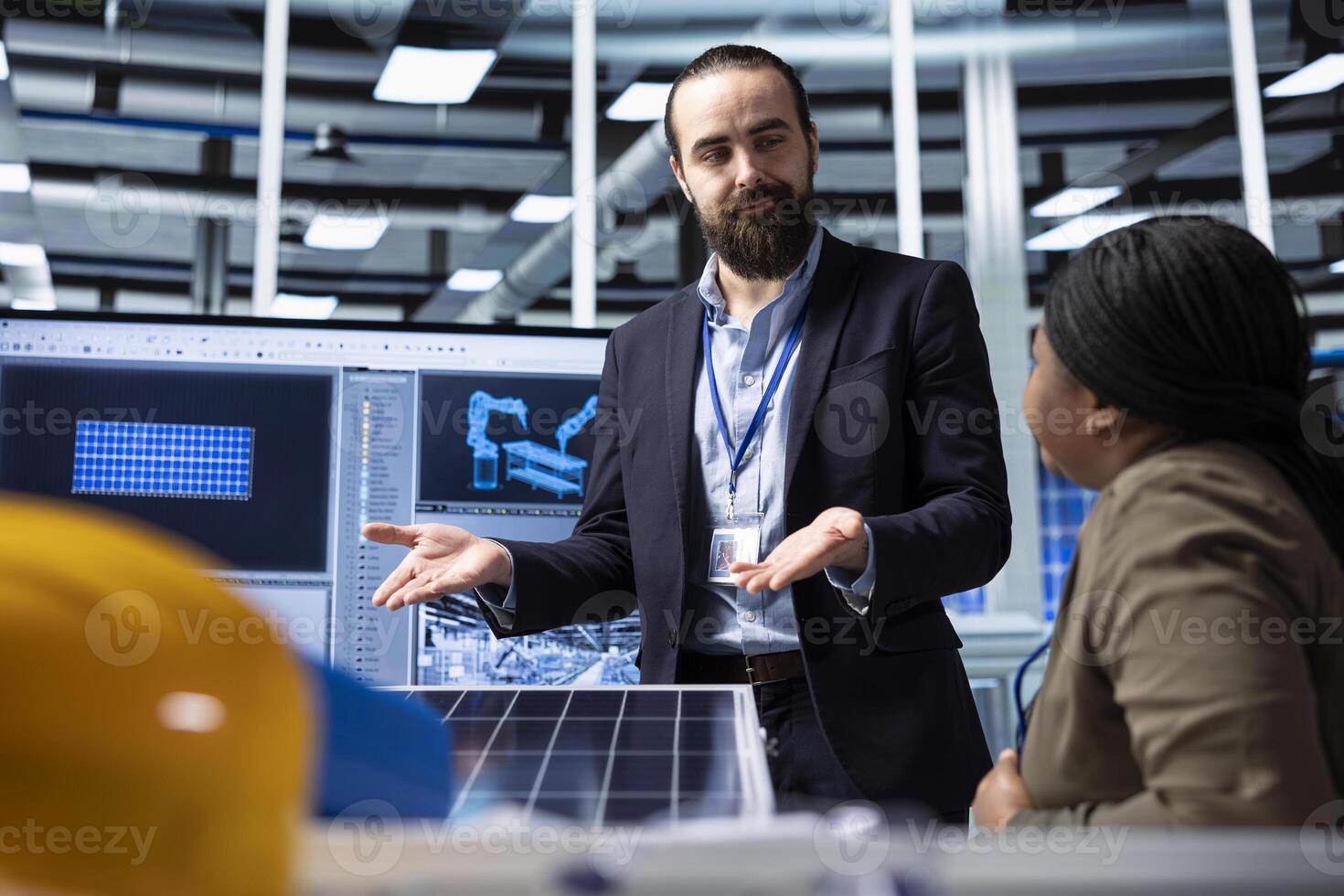 Photovoltaics factory businessmen discussing upgrades to make to improve sales. Solar panels manufacturing plant managers brainstorming ways to reduce downtime and increase production photo