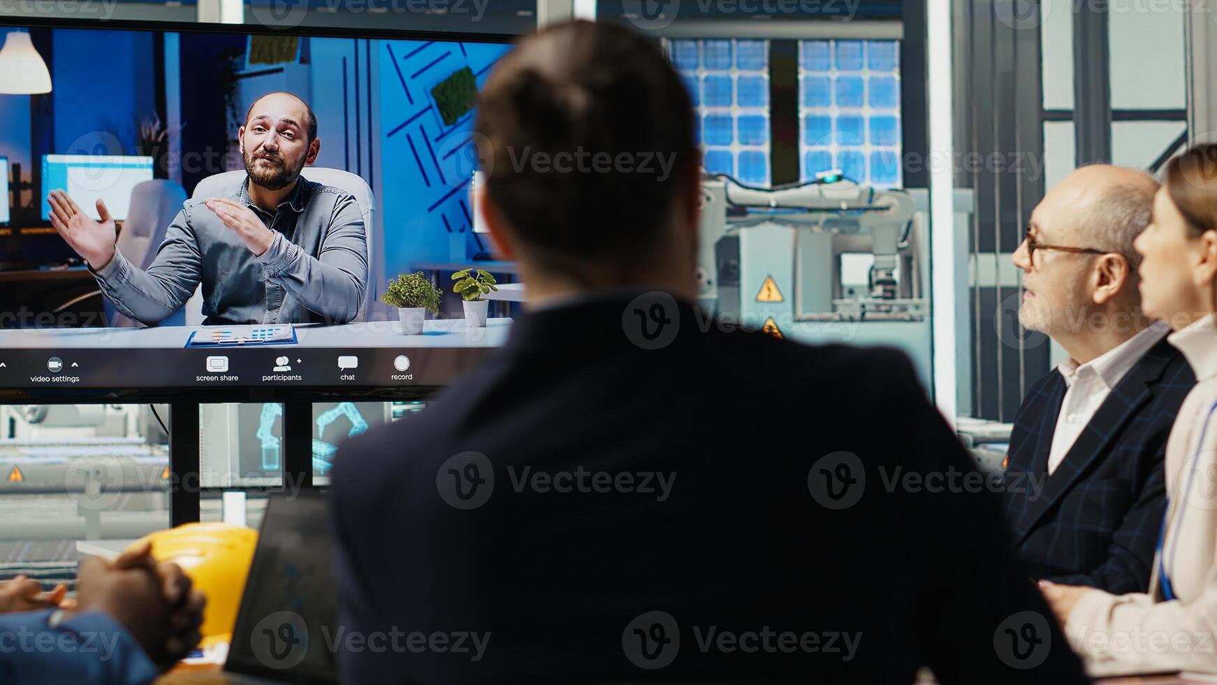 Experts optimize factory equipment energy output during teleconference call. Photovoltaics researchers doing videocall meeting, evaluating energy production, camera B photo
