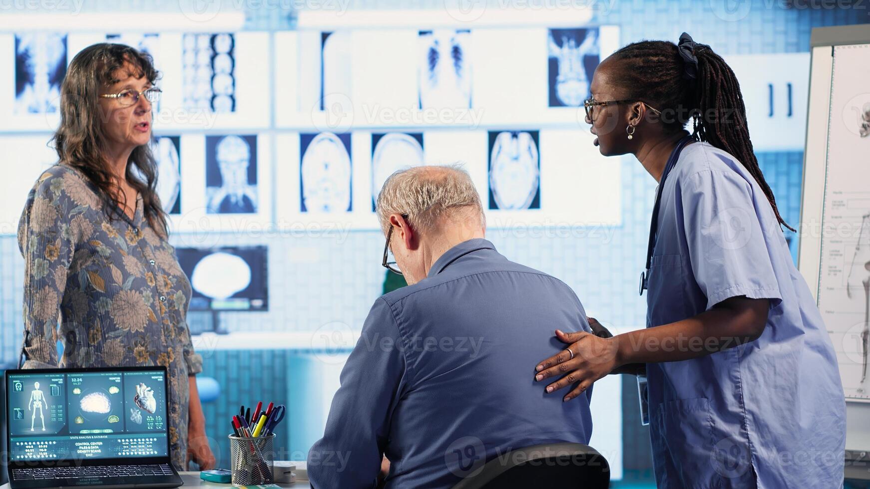 Healthcare expert conducts physical routine checkup on senior patient, addressing spinal issues and providing solutions for pain management and improved mobility in clinic. Camera B. photo