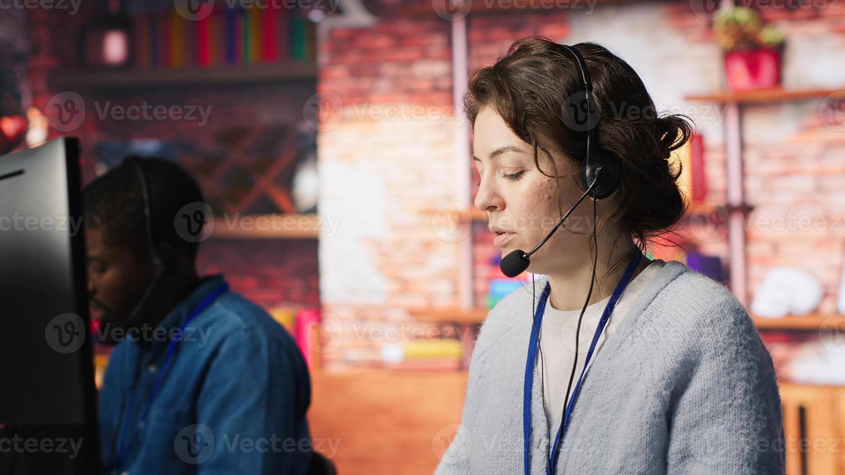 Call center agent helping customers regain access to accounts, resetting passwords. Employee assisting clients needing help by providing helpful solutions, camera A photo