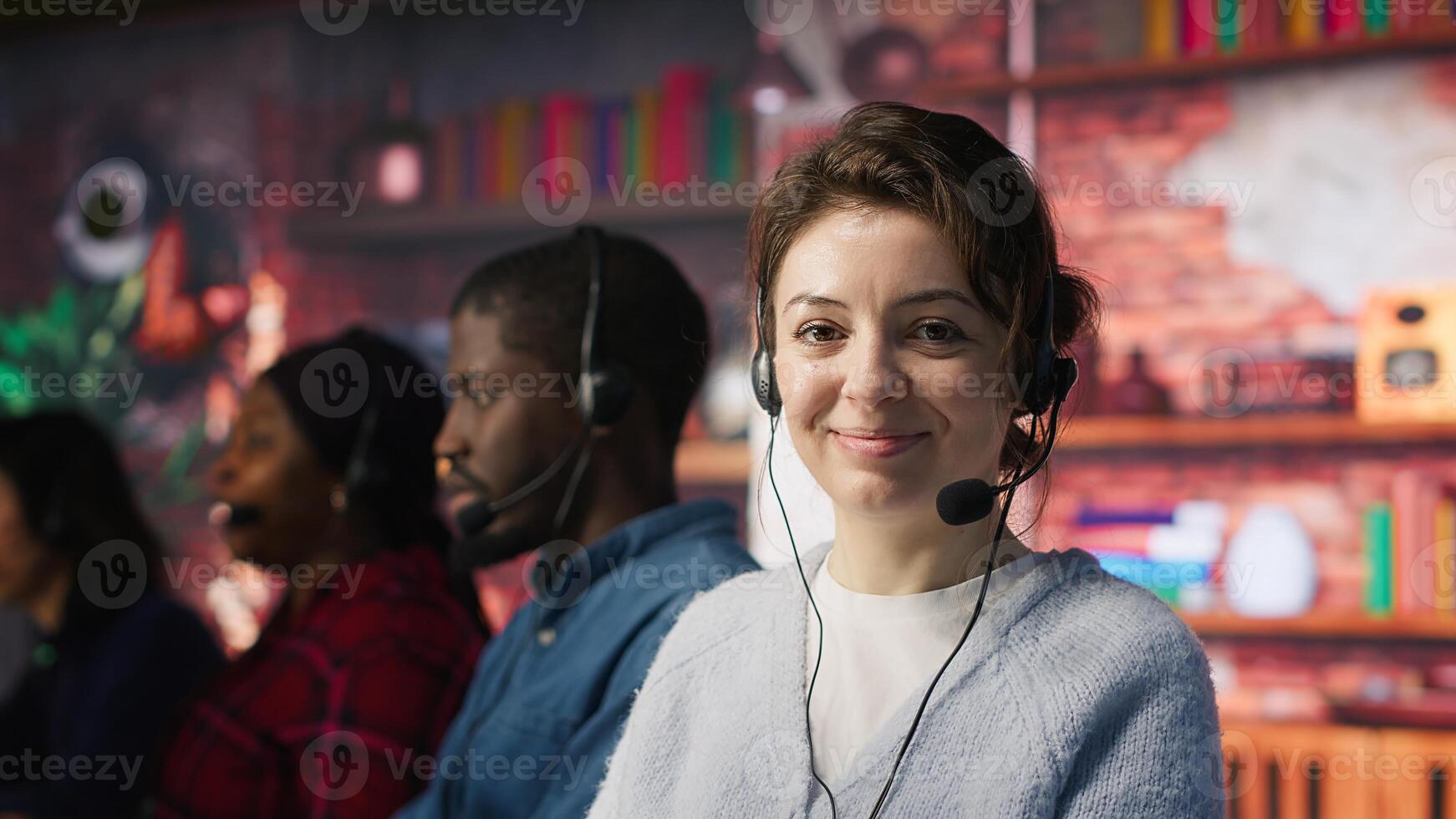 Friendly customer support workers respond to inquiries about products or services. Cheerful call center agent in office providing accurate and satisfactory information to clients, camera A photo