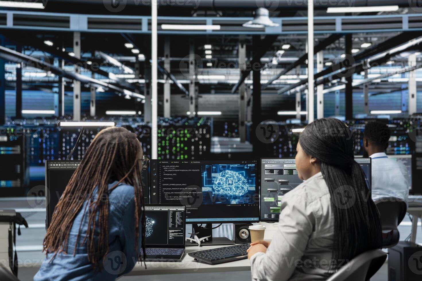 Data center engineering team working together, using AI visualization to oversee automated repetitive tasks. Server farm teamworking colleagues modifying systems based on data analytics graphs photo