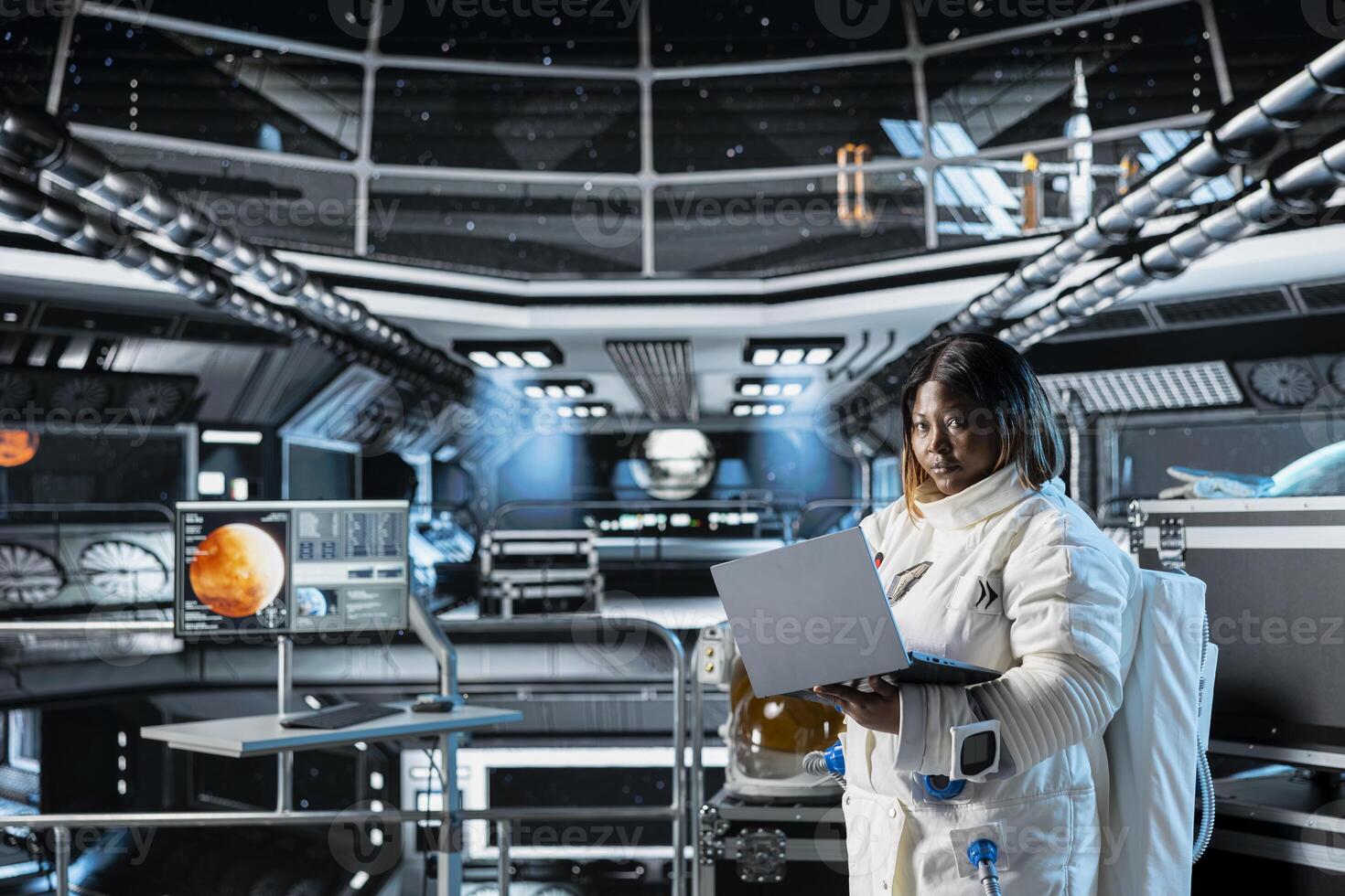 Female cosmonaut monitoring system diagnostics on laptop before Mars expedition. African american astronaut in spaceship explores red planet to support human life beyond Earth photo