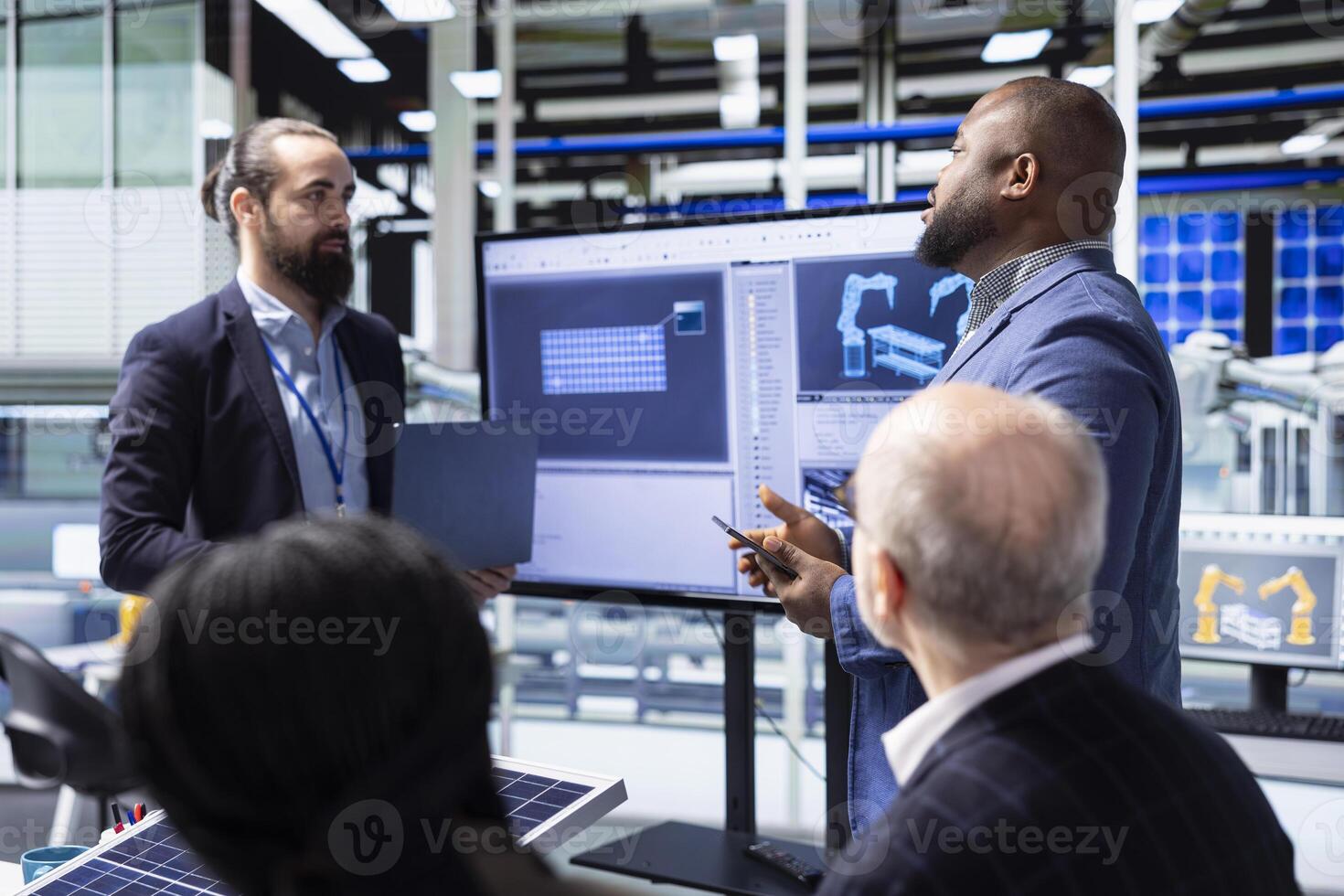 Investor addresses factory management during investment pitch meeting in photovoltaics plant, discussing robotics, automation processes and strategic growth opportunities photo