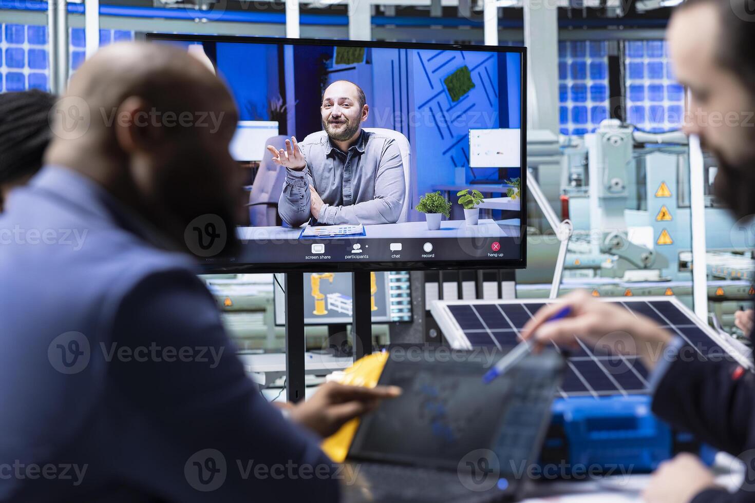 Photovoltaics factory managers visualize floor designs with 3D software on tablet during internet videocall. Solar panels plant businesspeople looking at CAD simulations during teleconference meeting photo