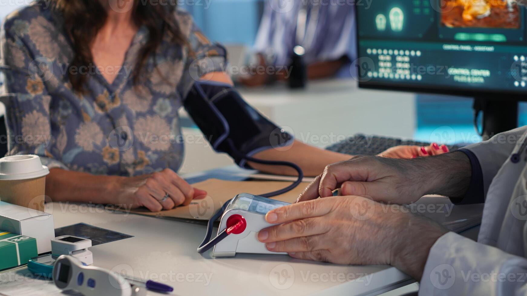 Senior physician measuring blood pressure, using professional tools at clinical consultation. Old doctor does tension reading and heartbeat measurement. Camera B. photo
