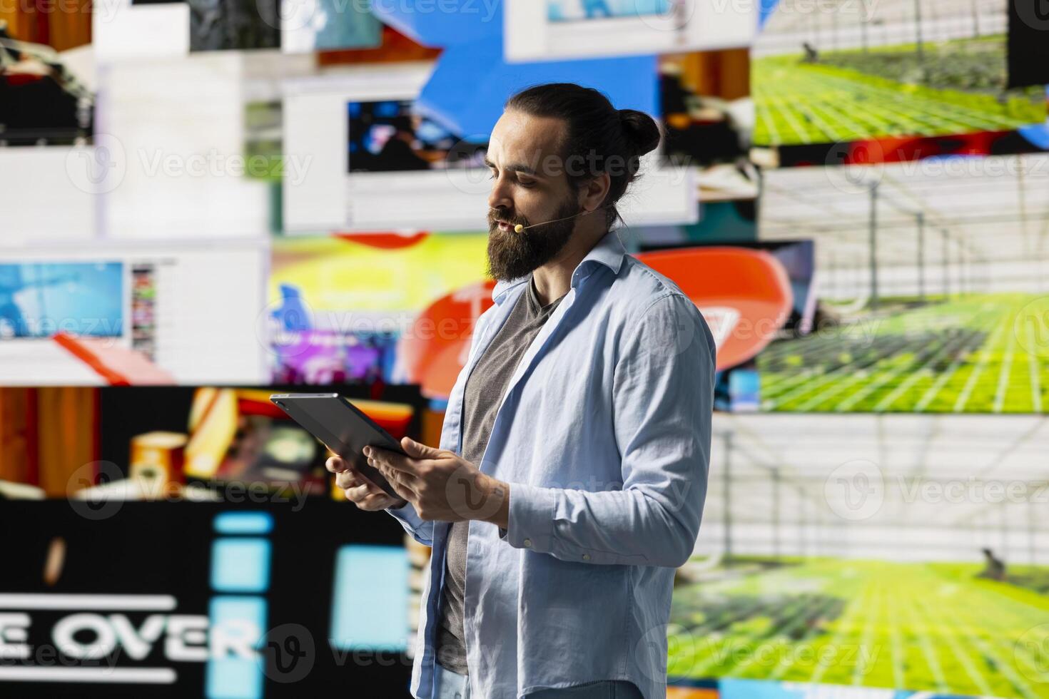 Male cool influencer hosting a live presentation with hands free microphone, engaging an audience to discuss social media reach, digital interaction and creative branding in real time. Trend setter. photo