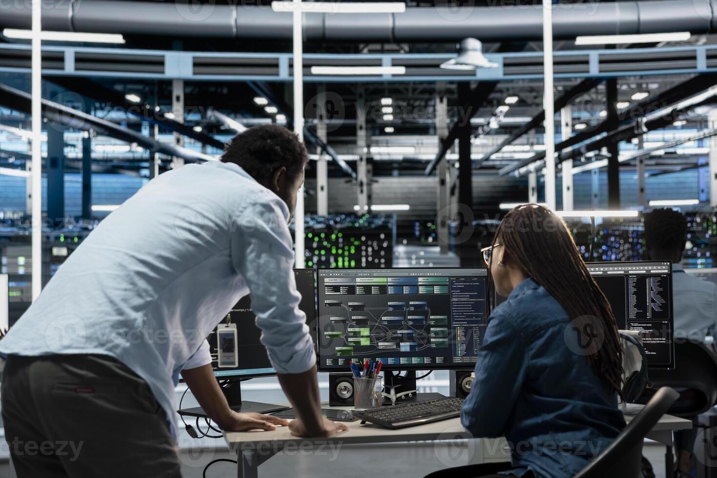 Data center computer scientists programming equipment used for machine learning training. Server farm IT experts working together, node trees code on PC to upgrade artificial intelligence systems photo