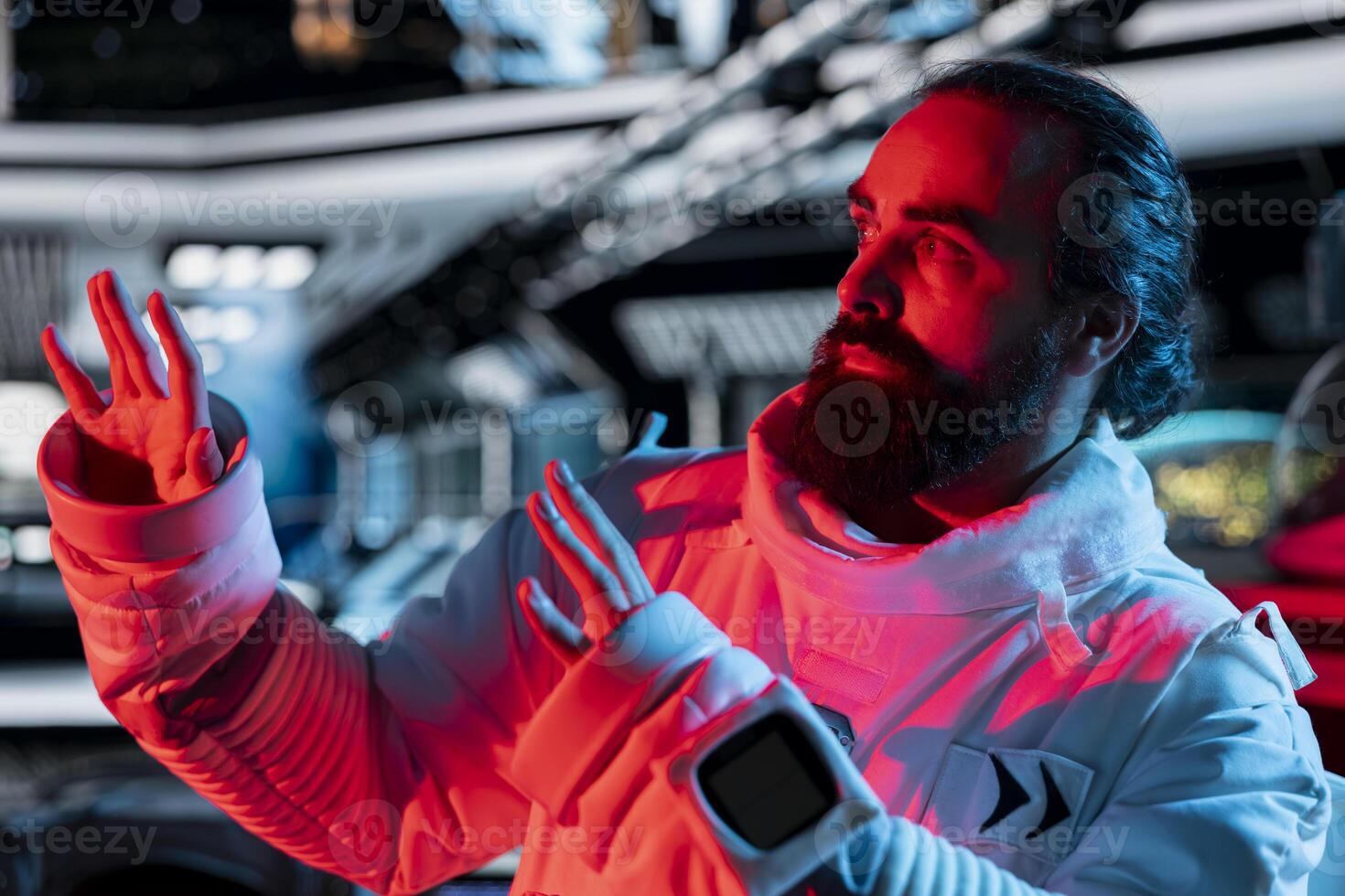 Scared astronaut in spaceship raises hand defensively during alien attack triggering onboard alert. Afraid orbital station crew member reacts to extraterrestrial form disturbance photo