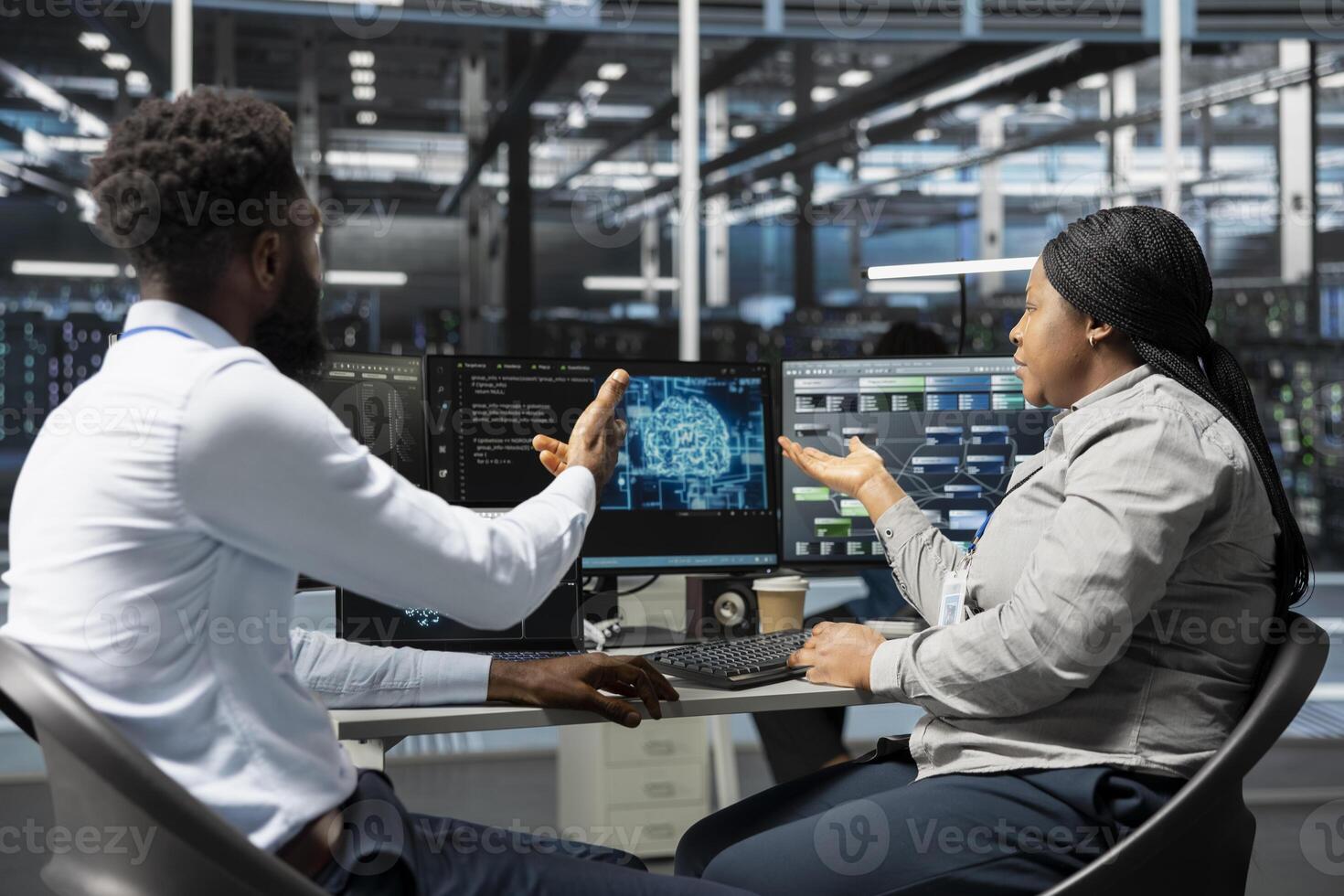 Server room software developers working together using artificial intelligence to reduce downtime. Workplace coworkers design and implement AI driven solutions for data center equipment photo
