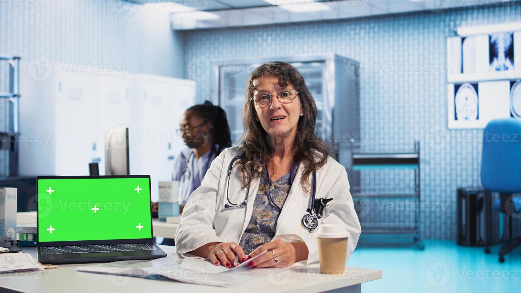 Physician doing checkup routine with patient next to chroma key screen, discussing about medicine and wellness. Man using health insurance for consultation with medic. Camera A. photo