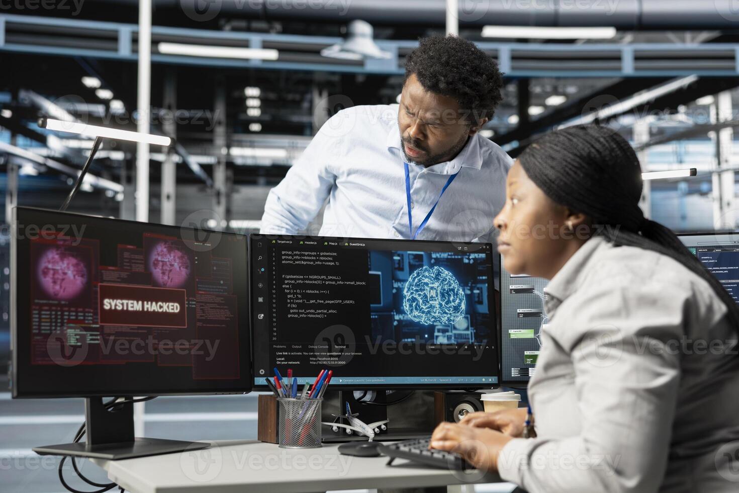 IT staff members in artificial intelligence server hub facility trying to protect servers from hackers. AI data center cybersecurity division colleagues protecting rigs during security breach photo