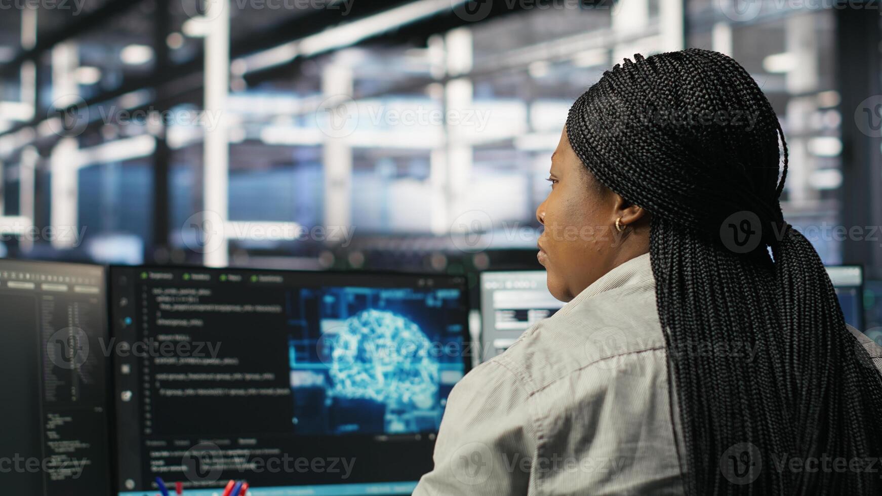 Data center worker applies deep learning node tree programming to analyze datasets for operational insights. Server hub admin uses visual programming to identify patterns in facility, camera B photo