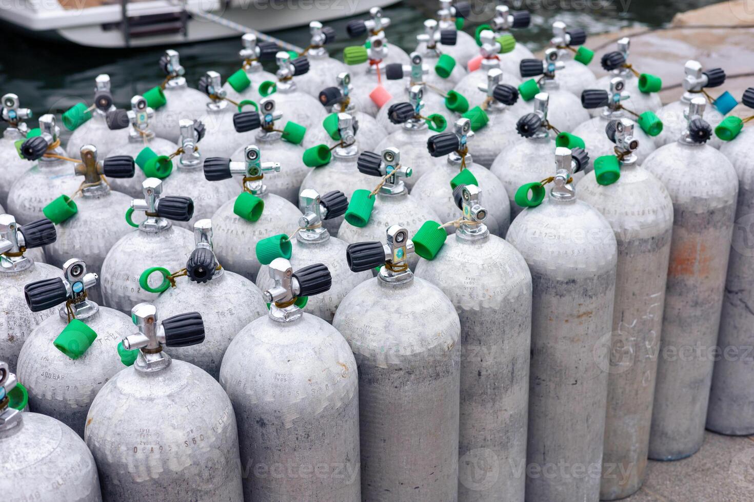Diving tanks arranged neatly at a marina in preparation for water sport activities photo