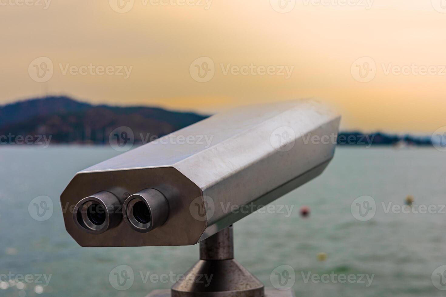 Viewing point offers stunning view of serene lake at sunset with distant mountains photo