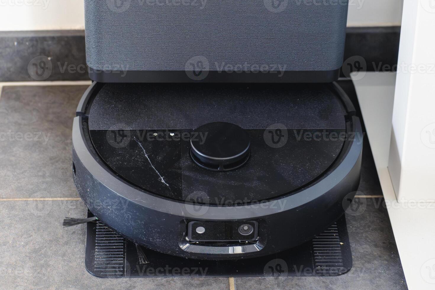 Robot vacuum cleaner with dust, real life photo, saves time and goes into hard-to-reach places, dust photo