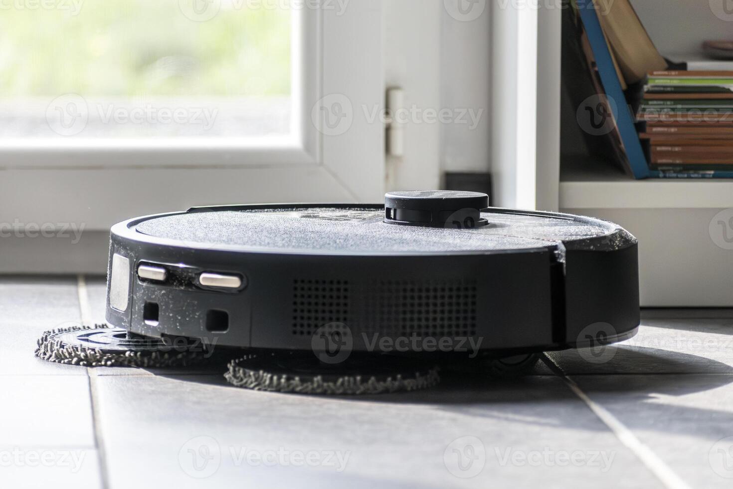 Robot vacuum cleaner with dust, real life photo, saves time and goes into hard-to-reach places, floor photo