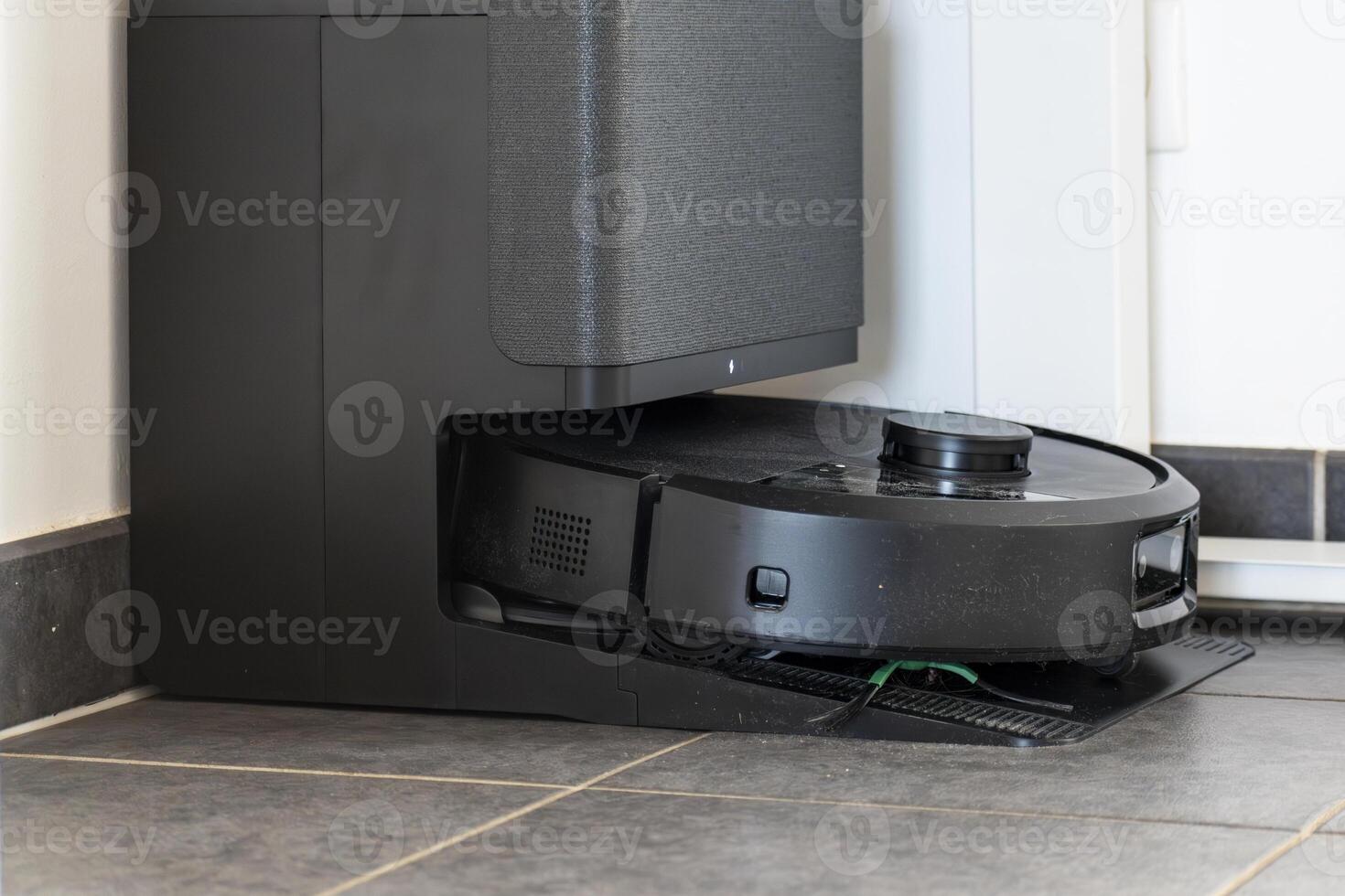 Robot vacuum cleaner with dust, real life photo, saves time and goes into hard-to-reach places, room photo