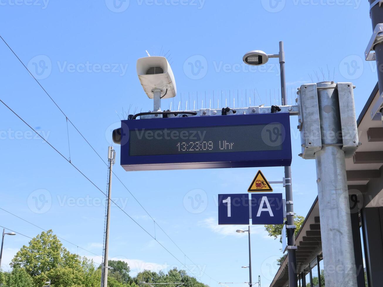 Digital Display Showing Time at an Outdoor Railway Station Platform photo
