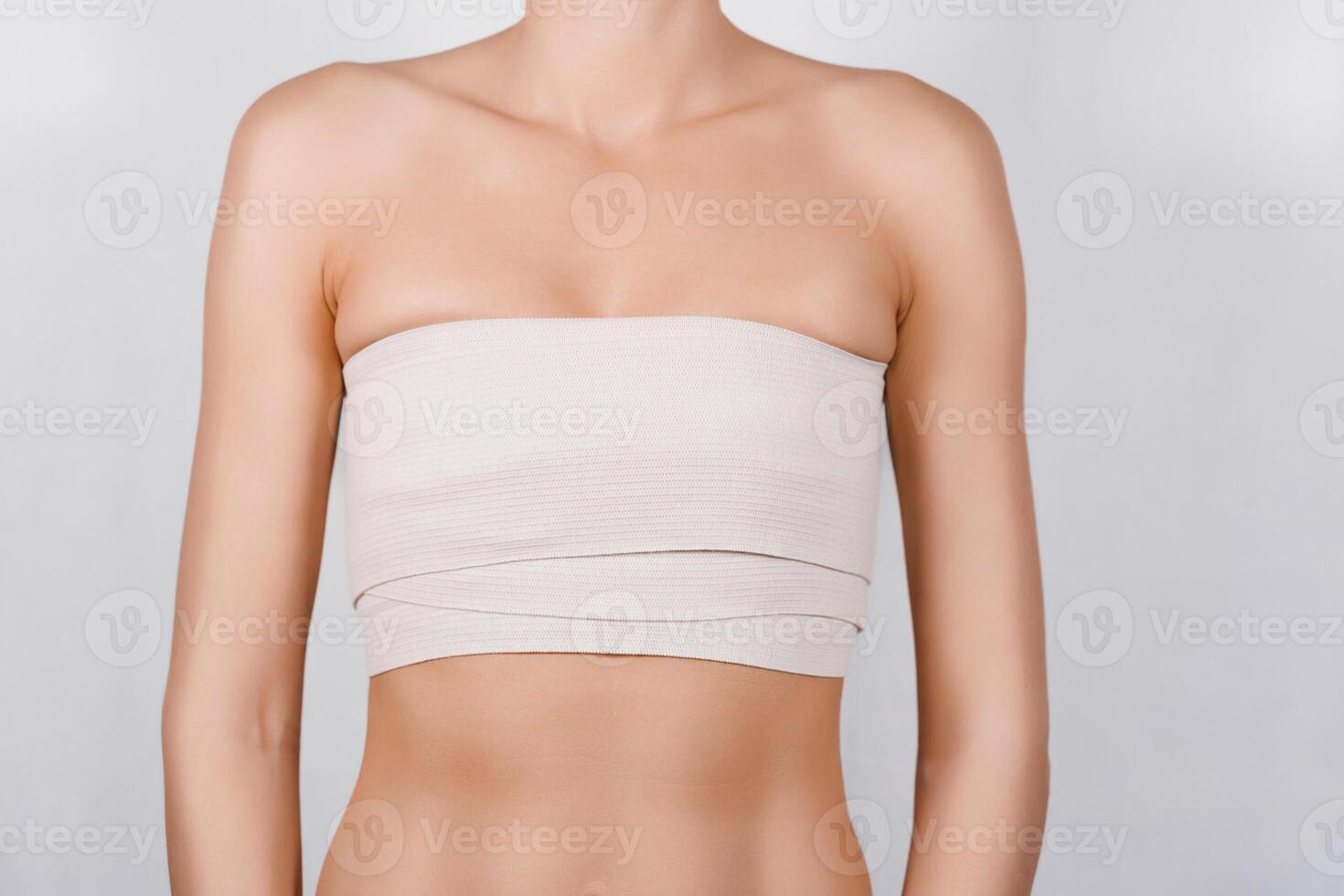 Close-Up of Woman's Breast Wrapped in Elastic Bandage After Tumor Biopsy Procedure for Analysis photo