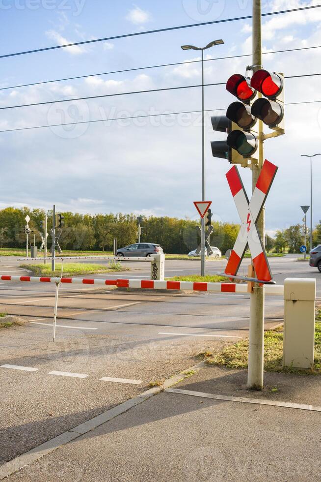 Closing barriers and flashing red traffic lights. ban on entering a railway and road crossing. photo