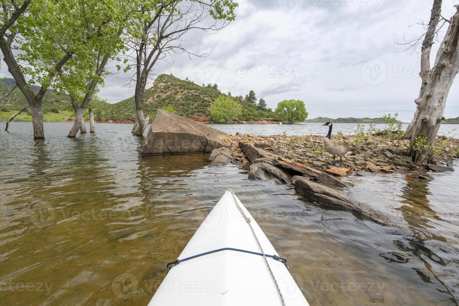 spring canoeing on Horsetooth Reservoir at foothills of Rocky Mountains near Fort Collins, Colorado - POV paddler perspective photo