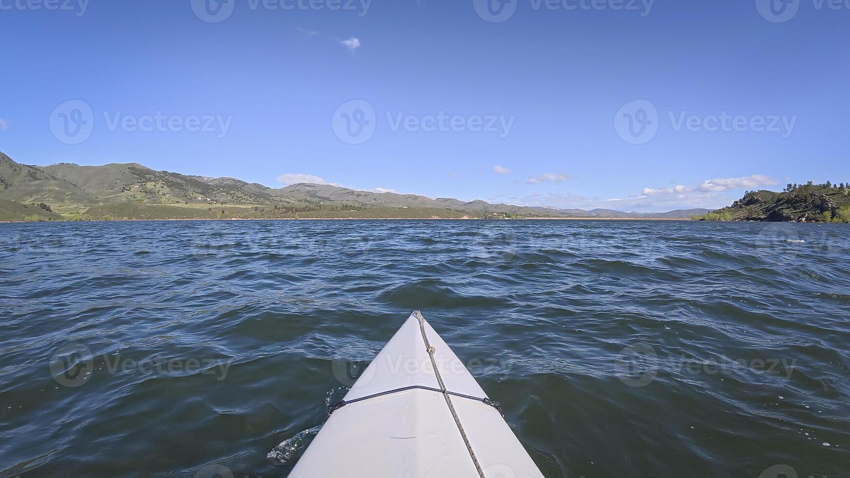 kayaking or canoeing on windy Horsetooth Reservoir near Fort Collins, Colorado - POV paddler perspective photo
