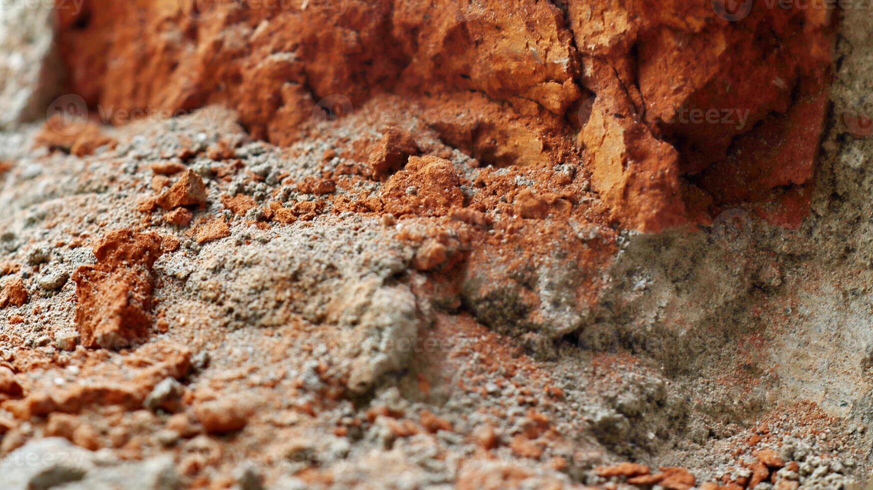 Broked concrete wall with lining from bits of broken brick. Used as a background. photo