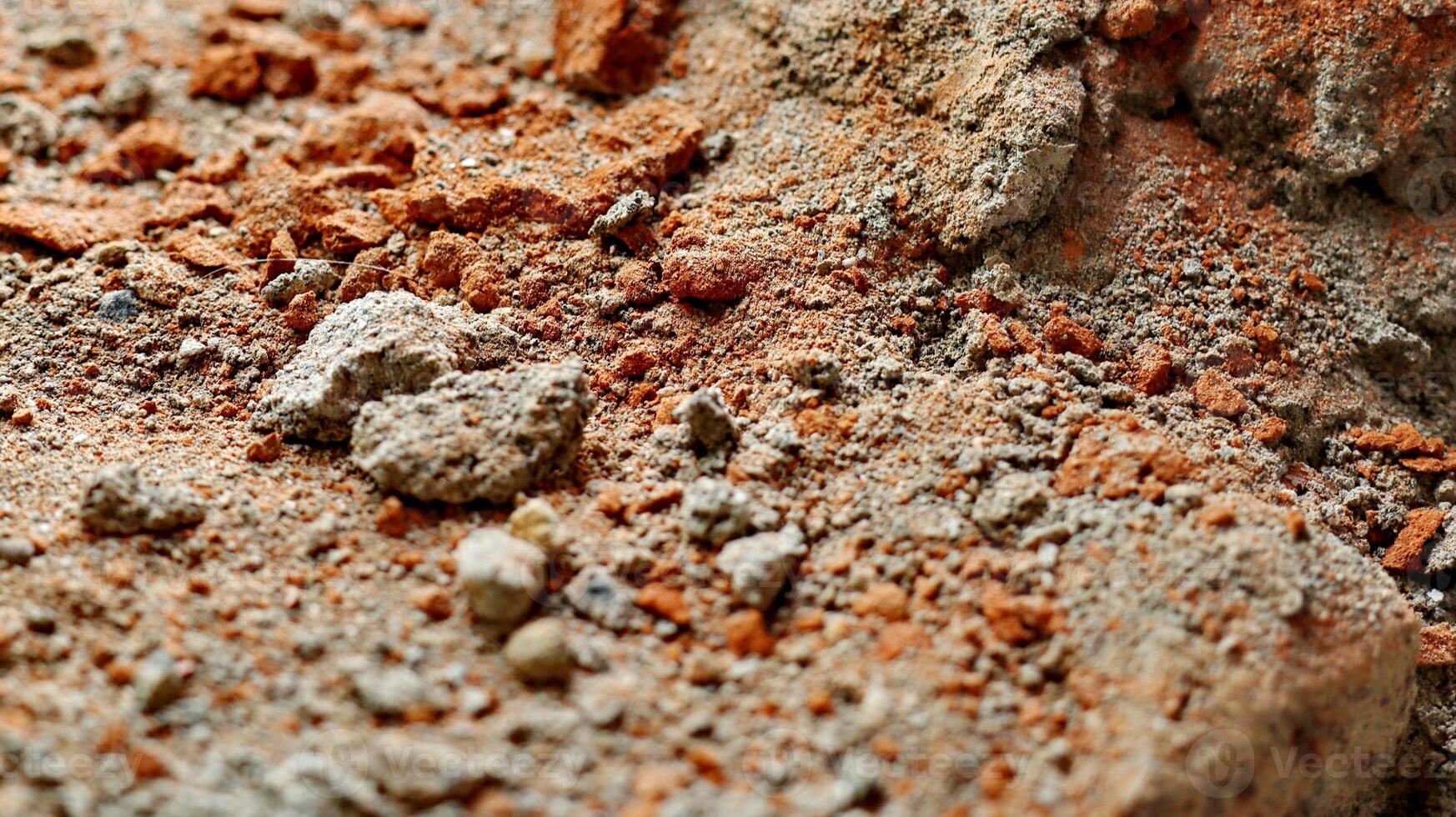 Concrete wall with lining from bits of broken brick. Selected focus. Used as a background. photo