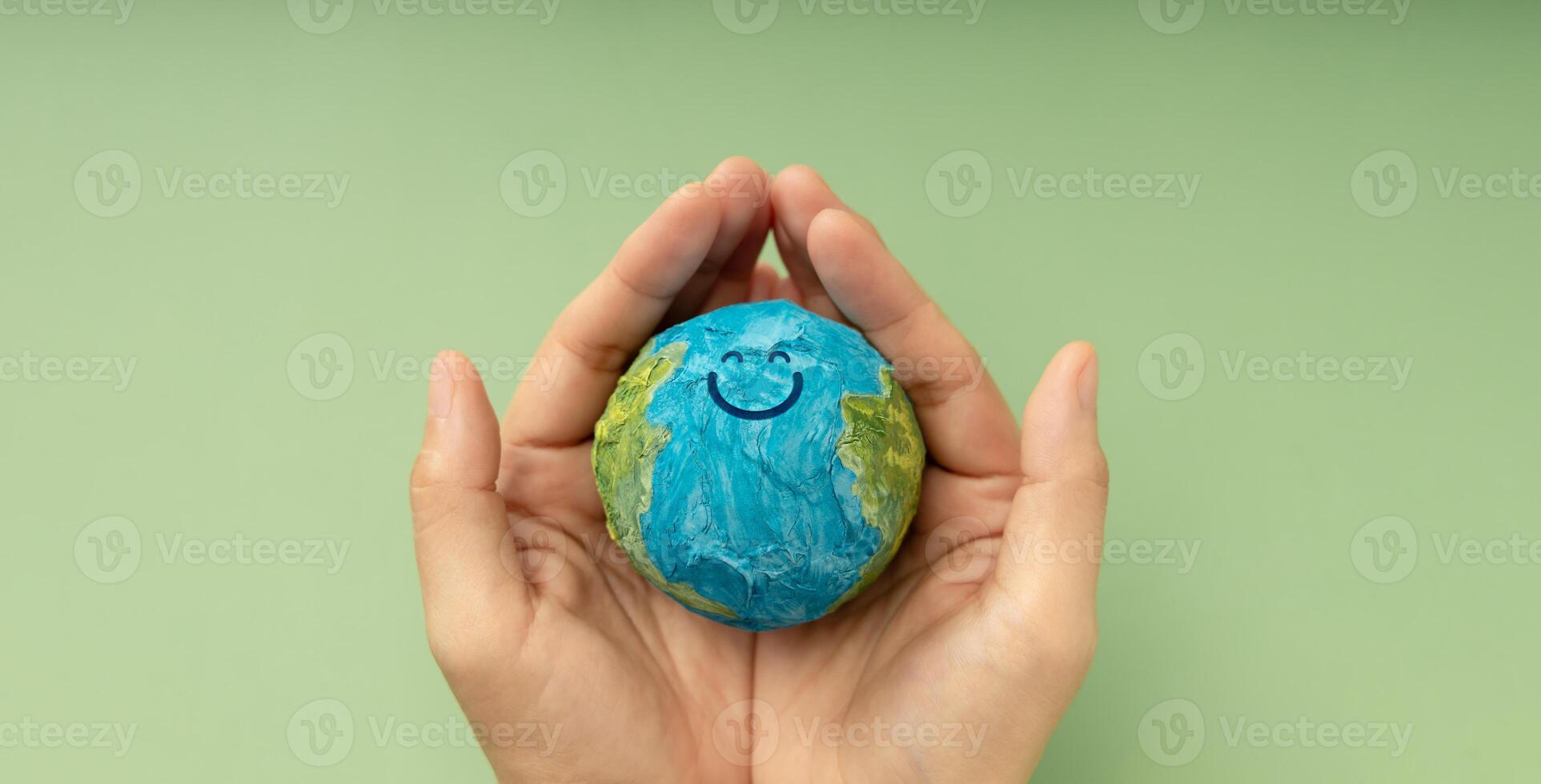Happy Earth in hands symbolizing sustainability, global happiness, environmental care, and ecological responsibility, Top View photo
