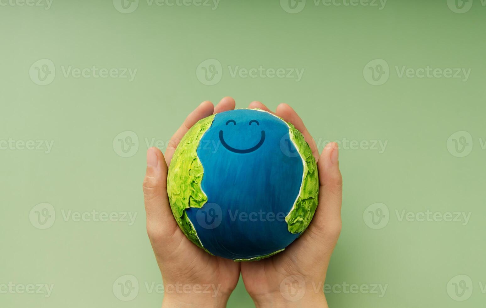 Happy Earth in hands symbolizing sustainability, global happiness, environmental care, and ecological responsibility photo