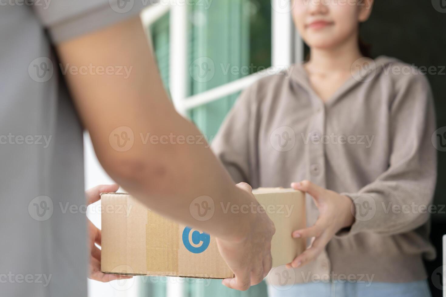 Happy smiling woman receives boxes parcel from courier in front house. Delivery man send deliver express. online shopping, paper containers, takeaway, postman, delivery service. photo