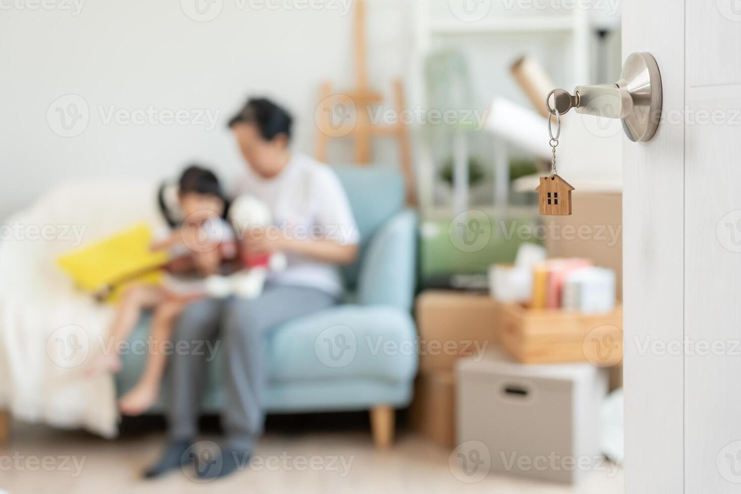 Moving house, relocation. open door found Family smile and play on new house, inside the room was a cardboard box contain personal belongings and furniture. move in the new apartment or home. photo