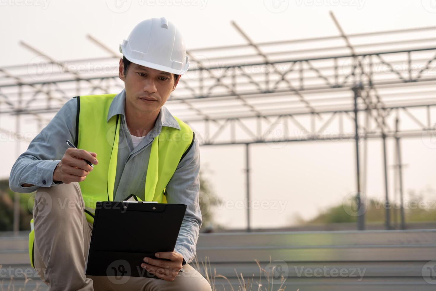 inspector or engineer is inspecting construction house using a checklist. Engineers and architects or contactor count materials for construction. Building, check, quality, foreman. photo