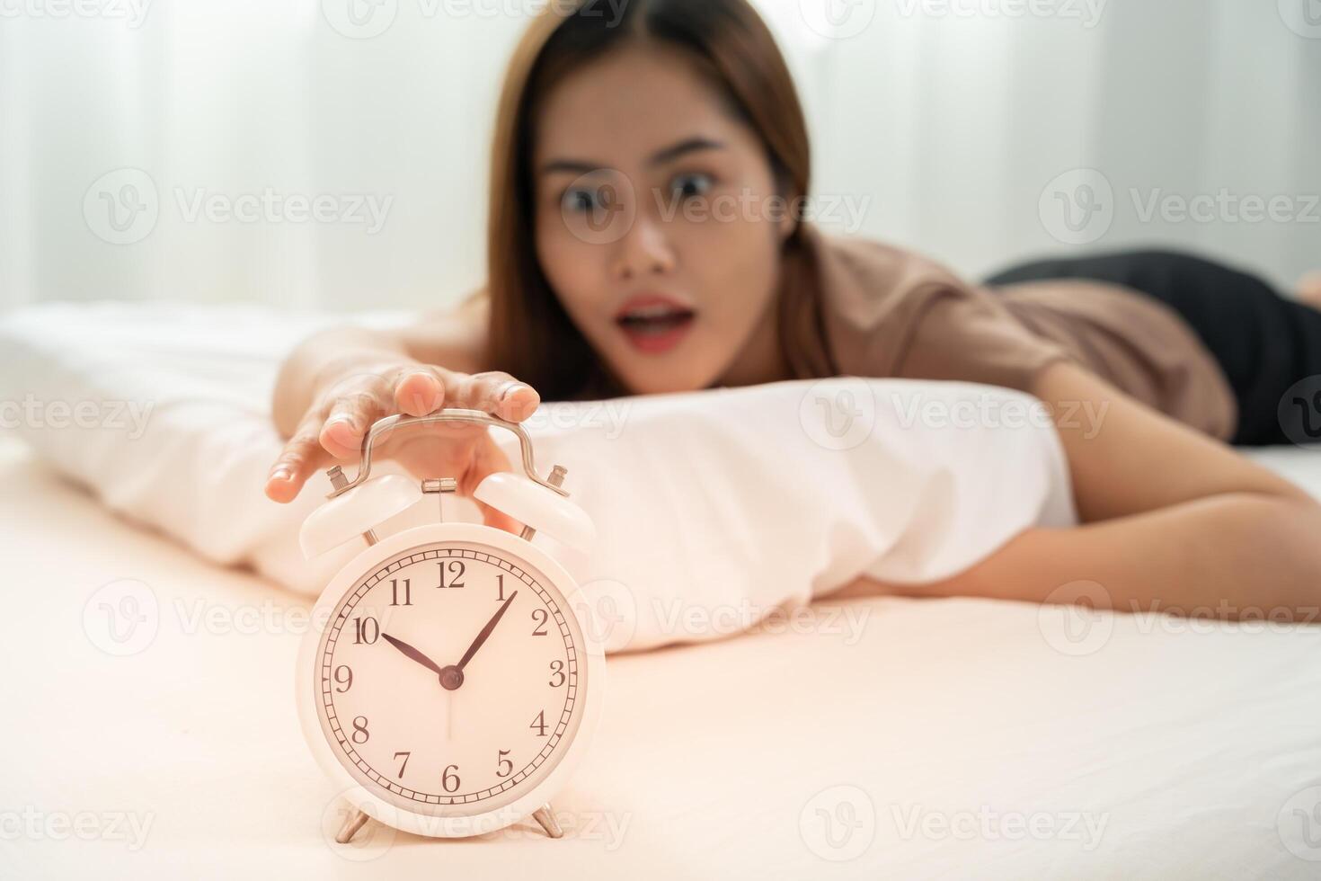 Stress young woman show clock alarm, lady is late appointment or work or class study, overslept, difficulty get up in mornings, time worried, not on time, sleepy, over due, Hurry up time photo