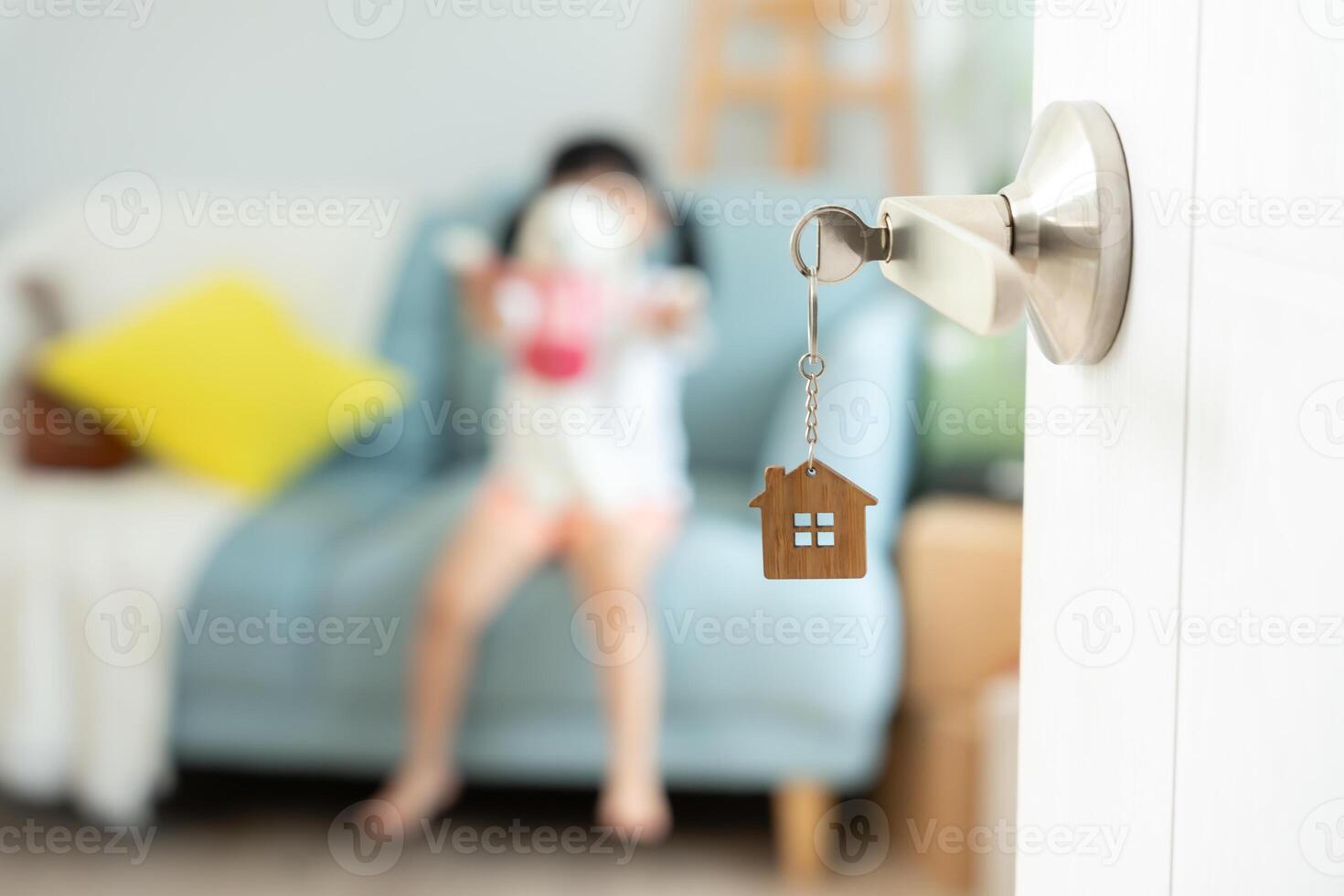 Moving house, relocation. Open the door found daugther play on new house, inside the room was a cardboard box contain personal belongings and furniture. move in the new apartment or home. photo