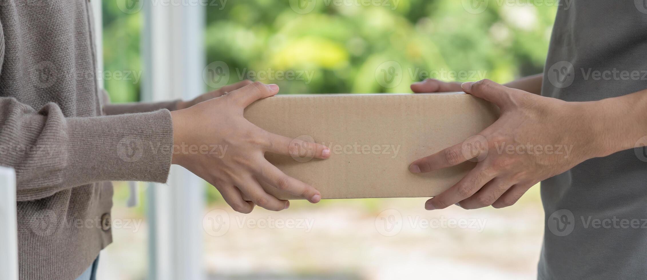 smiling woman receives boxes parcel from courier in front house. Delivery man send deliver express. online shopping, paper containers, takeaway, postman, delivery service, packages photo